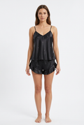 Black satin cami and ruffled shorts set on a female model against a white studio background